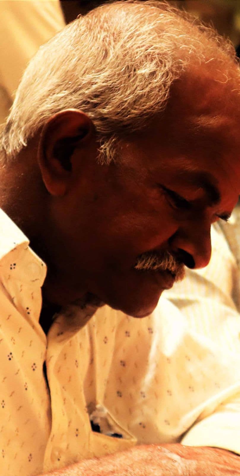An elderly man at a meal